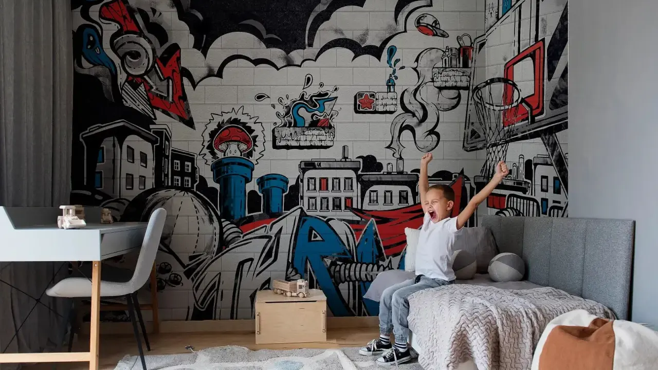 Chłopiec cieszy się w pokoju z dynamicznym **graffiti w pokoju** na ścianie, przedstawiającym miasto i elementy koszykówki.
