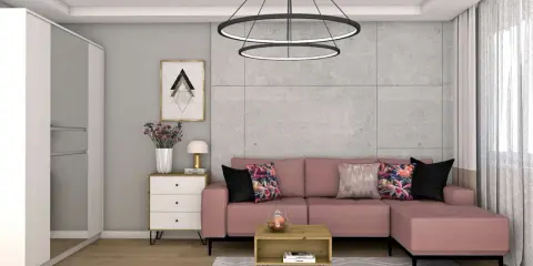 Różowa kanapa i kolorowe poduszki ocieplają szary salon. Wazon z kwiatami i stylowa lampka dodają przytulności.