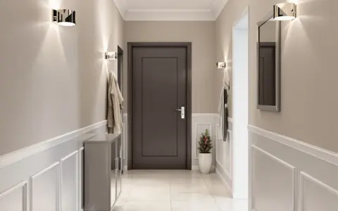 Nowoczesny przedpokój z praktycznymi ścianami ozdobionymi sztukaterią. Dyskretne oświetlenie i lustro dodają elegancji.