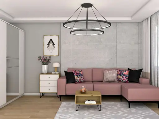 Różowa kanapa i kolorowe poduszki ocieplają szary salon. Wazon z kwiatami i stylowa lampka dodają przytulności.