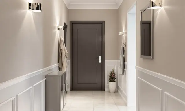 Nowoczesny przedpokój z praktycznymi ścianami ozdobionymi sztukaterią. Dyskretne oświetlenie i lustro dodają elegancji.