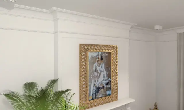 Eleganckie wnętrze z obrazem w złotej ramie i stylowym **klejeniem sztukaterii** na ścianie.
