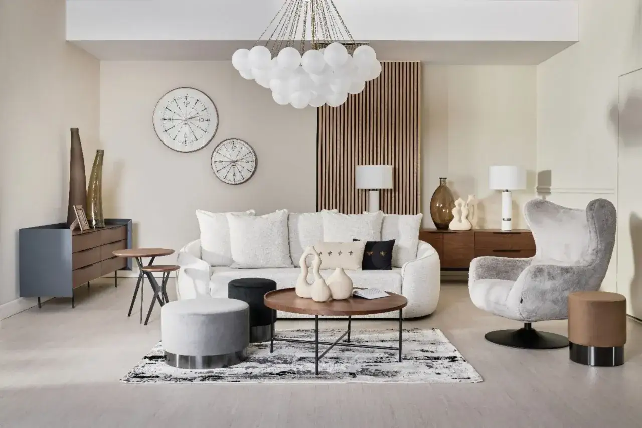 Przytulny, modern classic salon z białą sofą, szarą fotelem i dekoracjami ściennymi.